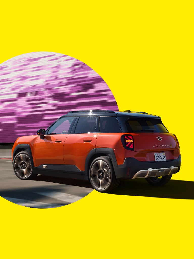 In motion, the first-ever all-electric MINI Aceman stands out against an abstract, colourful background.