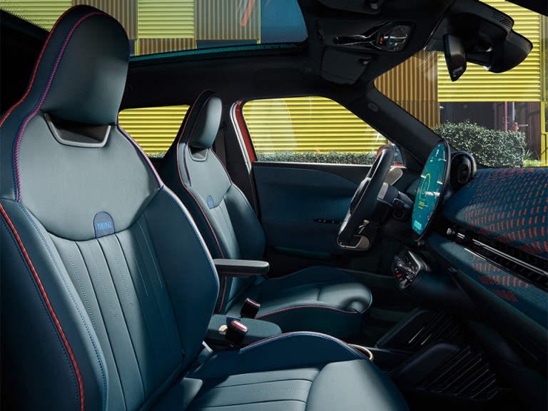 The new MINI Aceman’s stylish interior from a side-window perspective.