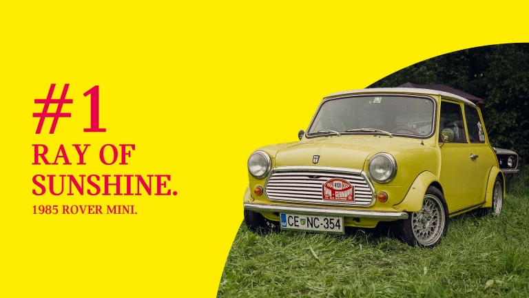Front view of a yellow 1985 Rover Mini parked on grass, titled “#1 Ray of Sunshine.”