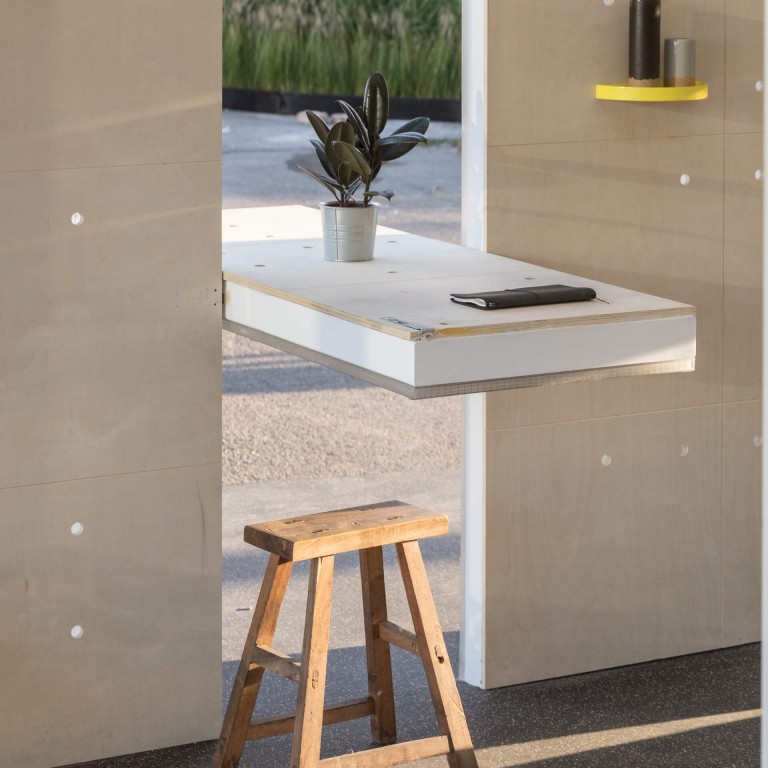 Rotating wall panel that doubles up as a work and dining table in the MINI LIVING Urban Cabin.