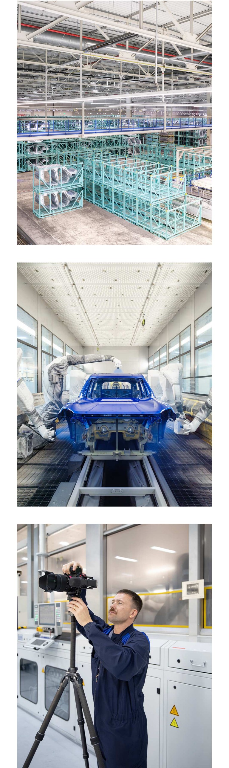 Car parts in aquamarine-coloured storage frames at BMW Group Plant Leipzig. Car body shell in the process of being painted an electric blue colour in the BMW Group Plant Leipzig paint shop. Pictured, Alastair Philip Wiper in a navy-blue factory uniform as he adjusts his camera and tripod.