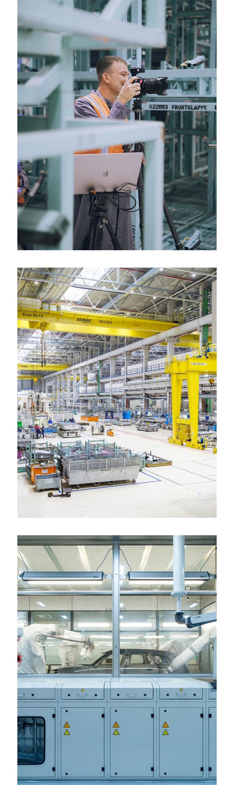 Side shot of Alastair Philip Wiper behind the camera, as he photographs BMW Group Plant Leipzig. Sweeping view of the factory floor at BMW Group Plant Leipzig. Photographed through the protective glass, a MINI Countryman being worked on by the paint-shop robots.